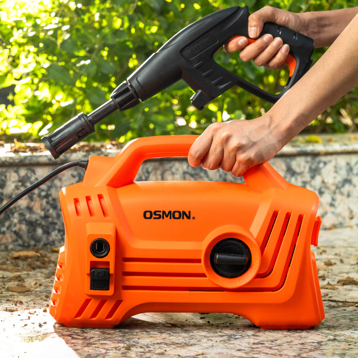 The image showcases the OS PW120 Flow High Pressure Washer, designed for efficient cleaning of cars, bikes, and homes. The pressure washer is featured in a vibrant orange color, adding a touch of style to your cleaning routine with its Pressure gun in black colour
