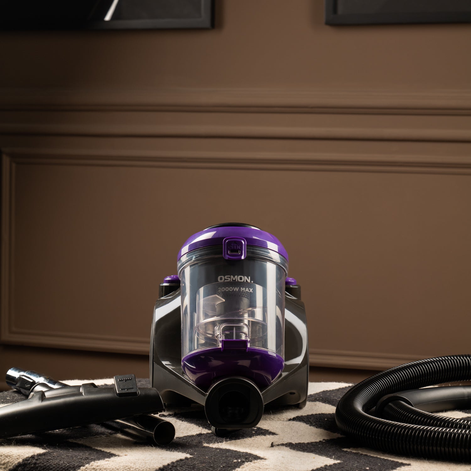 A sleek purple and black vacuum cleaner, the OS 2000BL, stands tall against a backdrop of a clean and tidy living room. Its compact design and HEPA filter make it an ideal choice for effortless cleaning